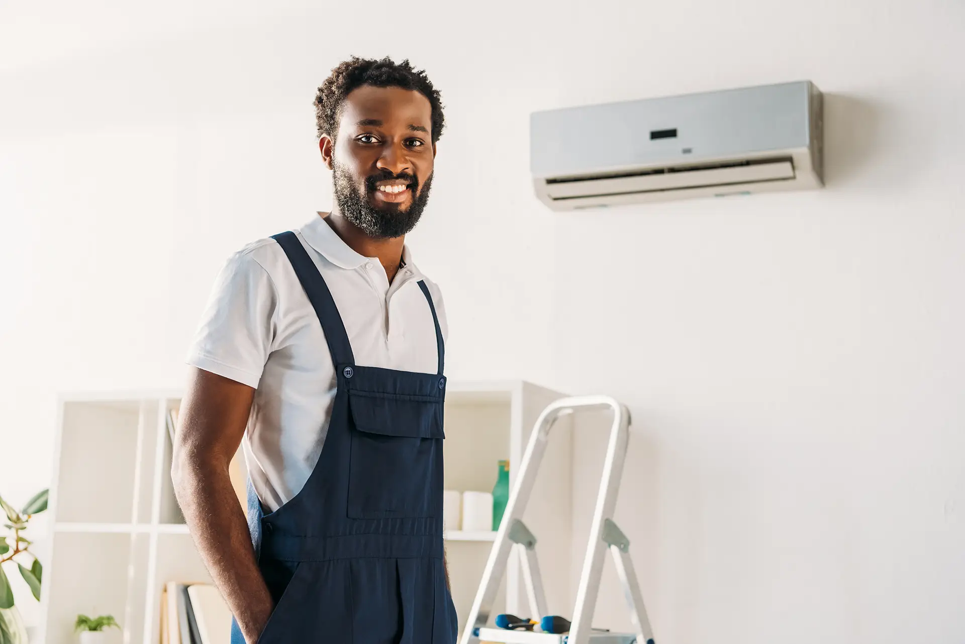 Man Standing in Front of Ductless AC