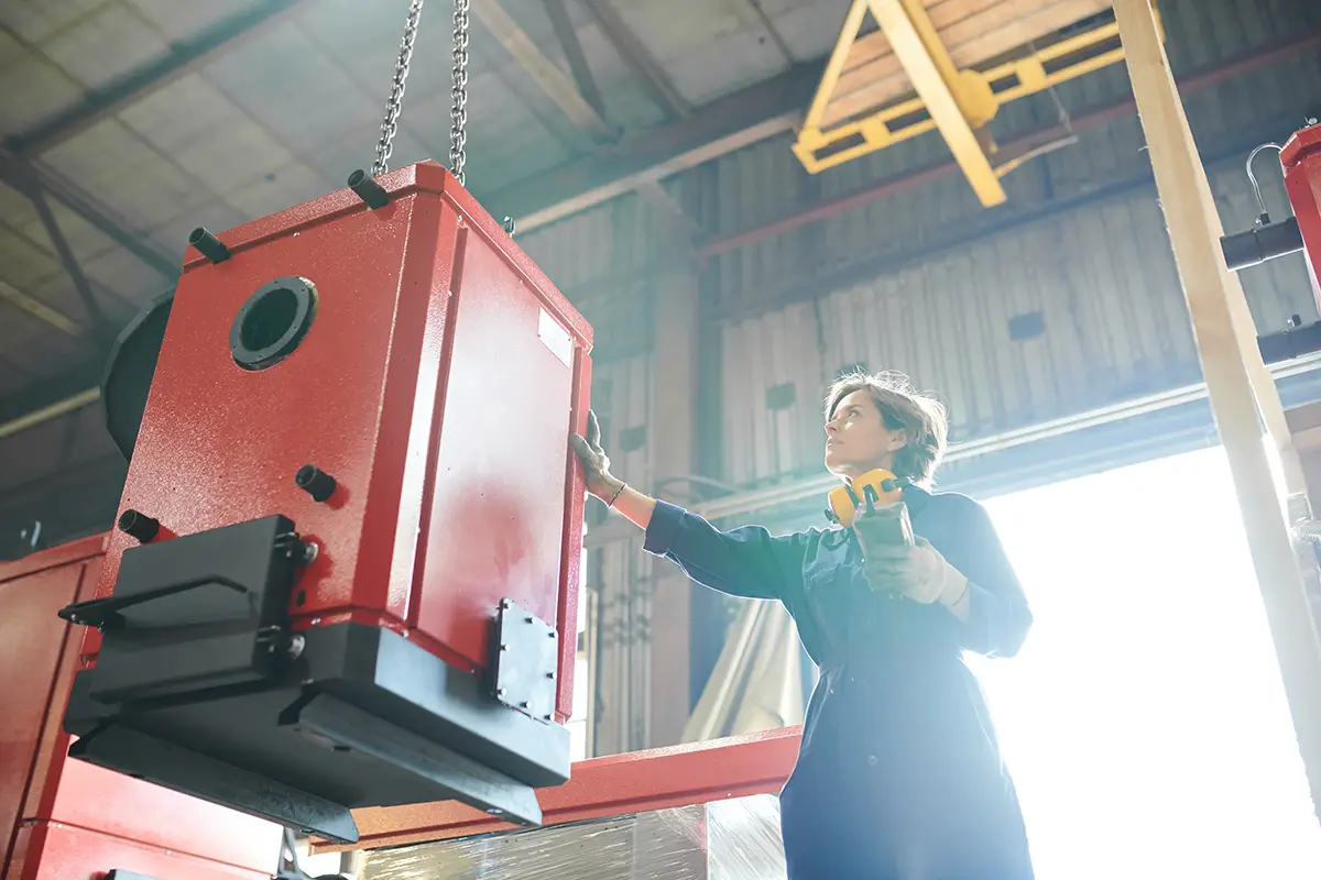 Woman Inspecting Electric Furnace