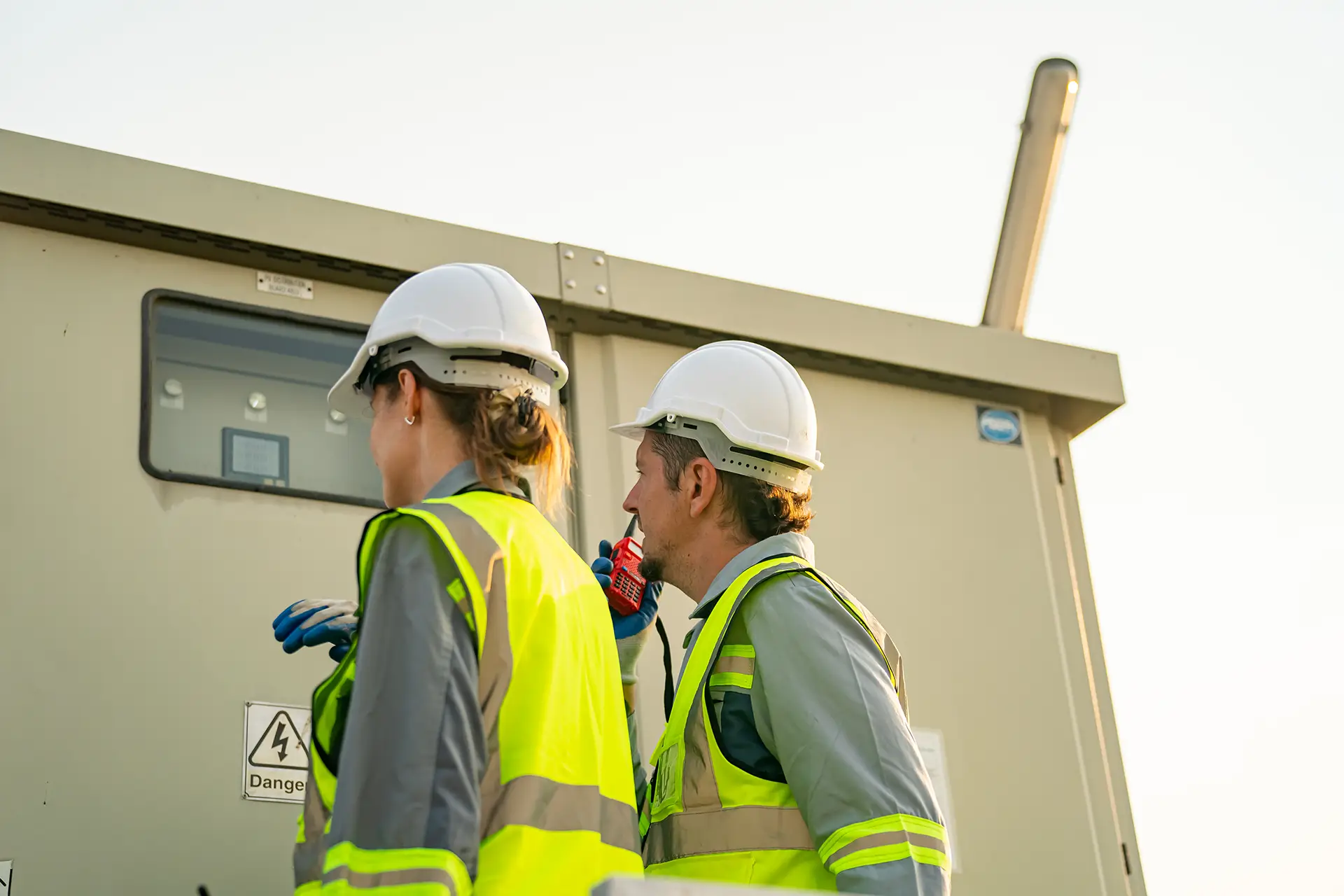 Electrical Workers Inspecting Generator in the Field