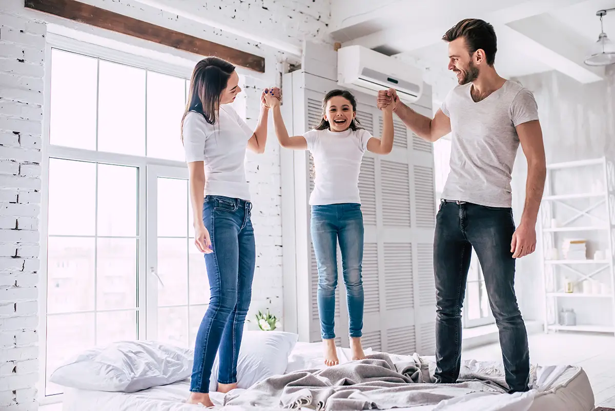 Family Jumping on Bed by AC